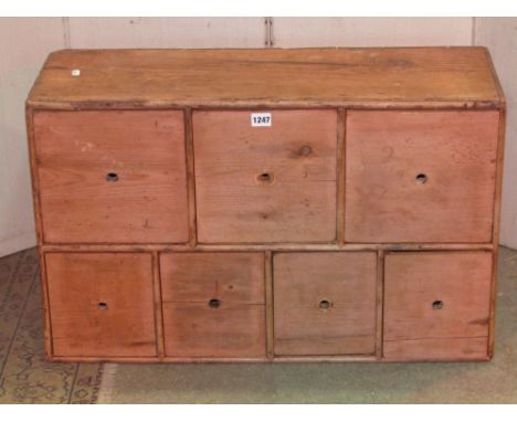 A vintage stripped pine nest/bank of seven drawers, 66 cm wide x 26 cm deep x 48 cm in height