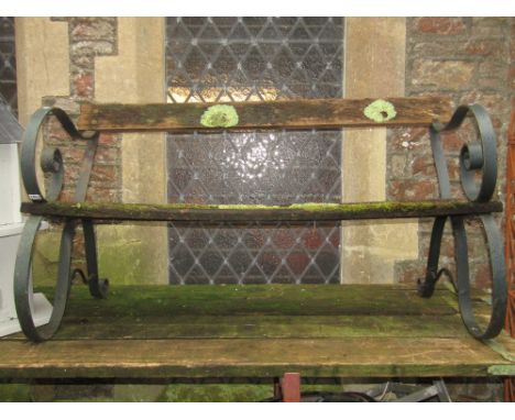 A sprung steel two seat garden bench with weathered timber lathes, 135cm long