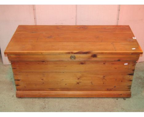 A stripped pine blanket box/trunk with hinged lid and side carrying handles, together with a small eastern occasional table o