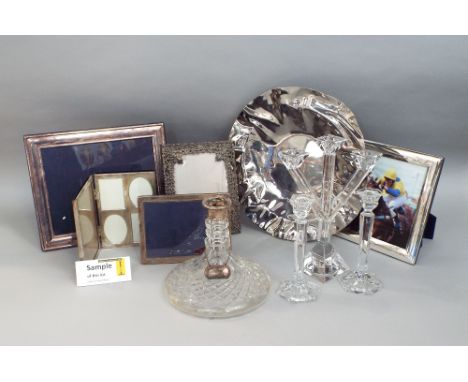 A mixed collection of glass and silver ware to include two silver applied easel frames, a silver collared ships decanter with