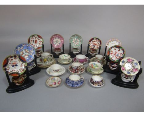 A collection of miniature early 19th century and later cups and saucers, coffee cans and saucers, etc, comprising Spode examp