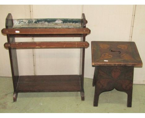 An Arts &amp; Crafts hall bench with plank through jointed seat, pierced window type panels and possibly later applied metal 