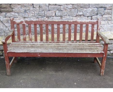 A weathered teak three seat garden bench, with slatted seat and back, 5ft long