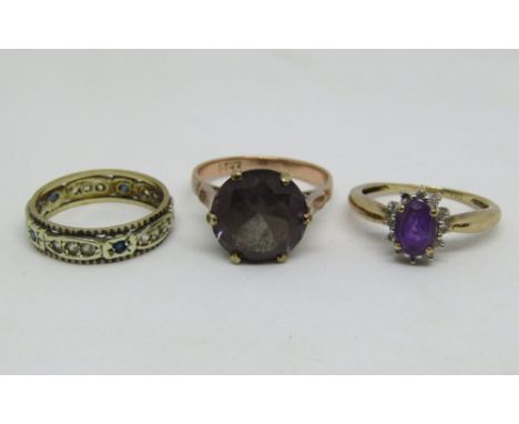 Three 9ct dress rings comprising a faceted amethyst coloured example, an amethyst and diamond cluster example (one diamond va