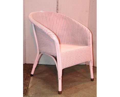 A Lloyd Loom tub chair with light pink colourway