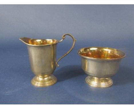 1970s Georgian style milk jug and sucrier with gilt interior and stepped circular bases, maker ATC, Birmingham 1973, the milk