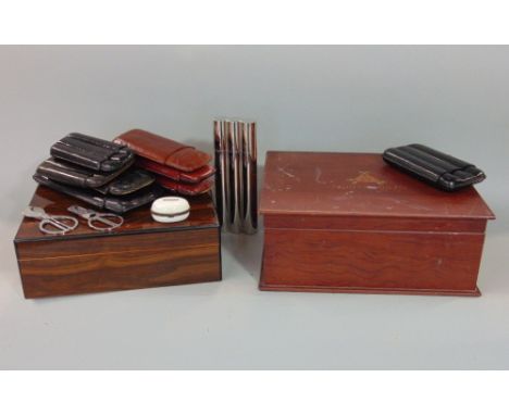 Two Humidors, one never used, the other with various leather and chrome cigar cases; together with an interesting late 19th c