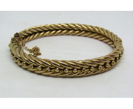 Victorian woven yellow metal hinged bangle, unmarked, tests as 9ct gold, 16.9g