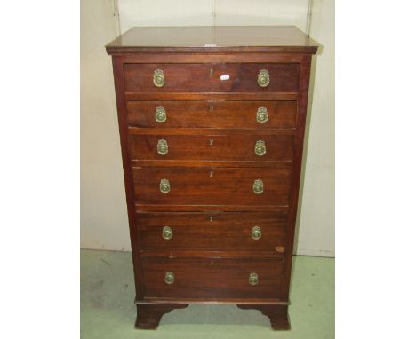 An Edwardian Georgian style walnut chest of six long graduated drawers with cast brass ring handles and bracket supports, 61 