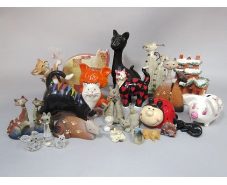 A collection of ceramic models of cats including a black glazed humorous example, together with an Arthur Wood pig money bank