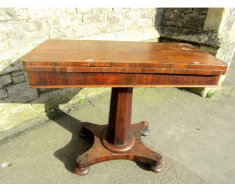 A Regency rosewood foldover top card table, raised on a tapering octagonal pillar and platform base