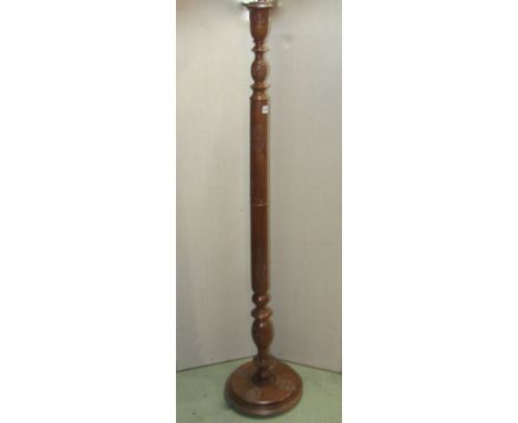 A Kashmir walnut standard lamp with carved foliate detail, turned stem, disc shaped platform base