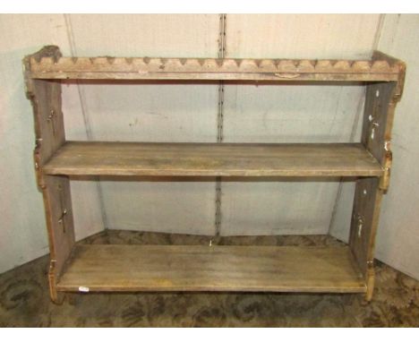 An Edwardian stool with oval pad seat, raised on turned supports and stretchers, together with a Gothic pine shelf (2)