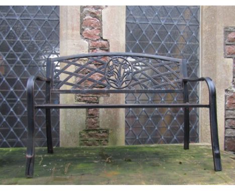 A contemporary light steel two seat garden bench with slatted seat and lattice panel back, central oval floral and dragon fly