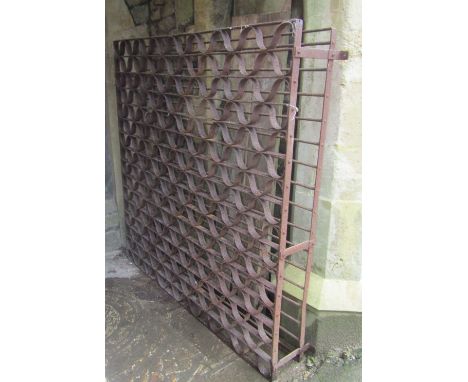 A large vintage heavy gauge ironwork wine rack, with undulating wave shaped carriers, approx. 180cm long x 30cm wide x 172cm 