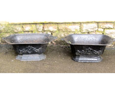 A pair of vintage French cast iron planters of rectangular form with canted corners, tapered and shaped bodies and stepped ba