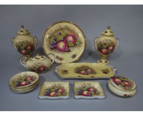 A collection of Aynsley Orchard Gold pattern wares comprising a pair of two handled vases and covers, 22.5cm tall approx., a 