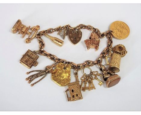 Good 9ct charm bracelet hung with thirteen 9ct / yellow metal novelty charms to include 1913 sovereign, telephone, 'Jersey' k