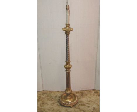 A gilt wood floor standing standard lamp in the form of a candle stand, with partially fluted and wrythen turned column raise