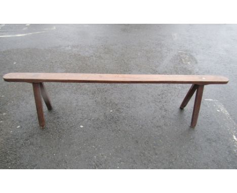 19th century fruitwood bench or form on four stick supports