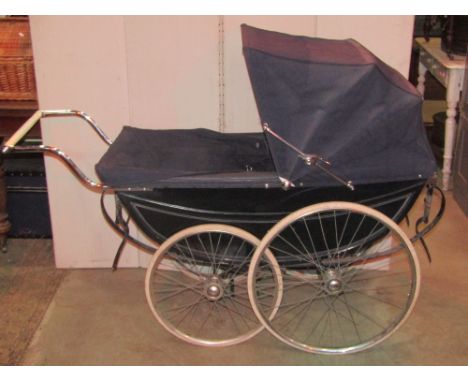A vintage coach built pram, labelled The London Baby Coach with painted finish, sprung frame and wire spoke wheels with hard 