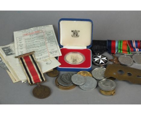 A group of five medals comprising the Order of St. John breast badge, 1939-45 Star, Defence Medal, War Medal, War Medal and a