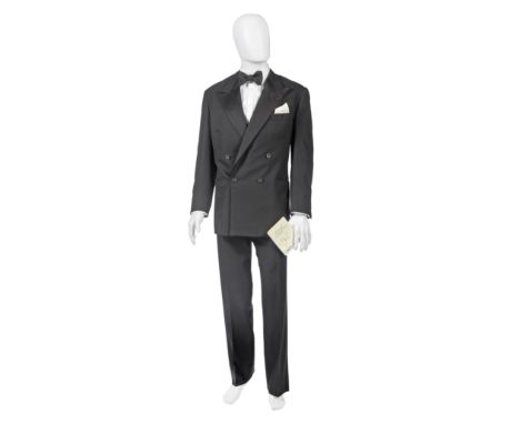 A Douglas Hayward bespoke double breasted dinner suit for Sir Roger MooreComprising a dinner jacket with wide silk lapels and