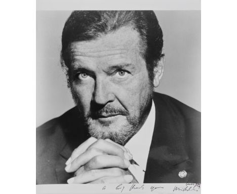 A large black and white portrait photographic print of Sir Roger Moore1990sPhotographic print stamped to reverse (c) Michel C