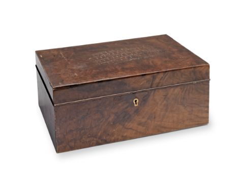 A walnut cigar humidor together with other cigar related itemsThe hinged rectangular lid enclosing a cedar wood lined interio