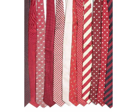 A selection of twelve silk ties belonging to Sir Roger MooreOf mainly red tones, to include: two red silk ties with white spo