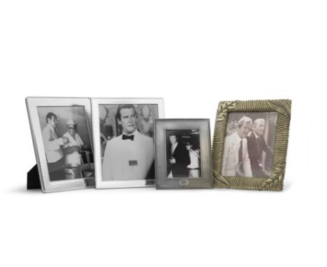 Framed photographs of Sir Roger Moore with Albert R. (Cubby) BroccoliThe pair photographed in a kitchen serving spaghetti, to