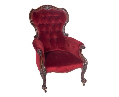 A Victorian carved mahogany armchair, with wine coloured dralon velvet upholstery to match the previous lot, having cartouche