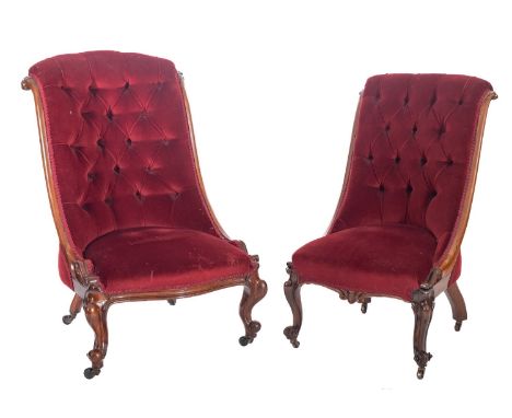 Two similar Victorian nursing chairs in carved rosewood and walnut, with upholstery to match the previous lots, having button