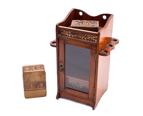 An Edwardian mahogany smoker's cabinet, early 20th century; with galleried top above a glazed door, the sides with hinge down