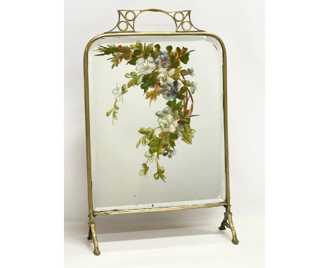 An Edwardian brass framed mirrored firescreen with hand painted flower decoration. 46x18x73cm 