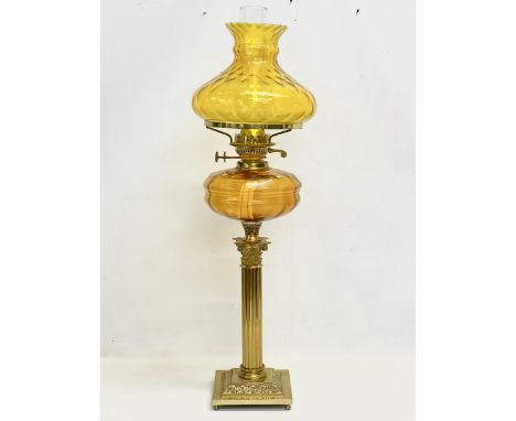 A large Victorian style double burner oil lamp with Amber Glass bowl, brass Corinthian style column and base. 75cm 