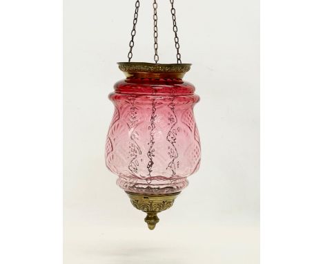 An early 20th century brass and Ruby Glass light shade. Circa 1900. Shade measures 21x34cm. 62cm including chain. 