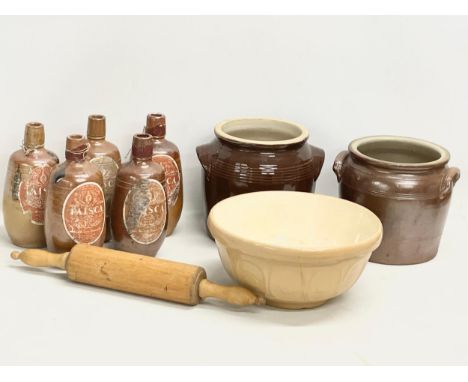 A collection of vintage stoneware. 5 vintage Portuguese Faisco wine bottles. A baking bowl. Rolling pin and 2 stoneware pots.