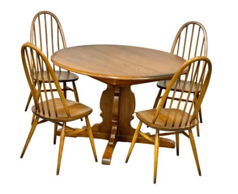 An Ercol Mid Century Elm extending dining table and 4 chairs. Open 165x115x72cm. Closed 114x72cm 