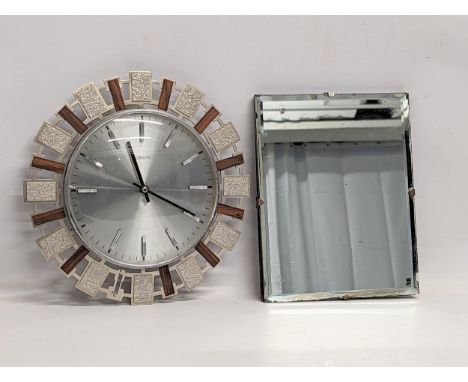 A 1930s Art Deco bevelled mirror with a 1960s Mid Century Sunburst Eurastyle wall clock. Mirror measures 20.5x25.5cm 
