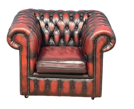 A deep button ox-blood leather club armchair. 