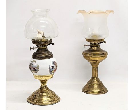 A vintage brass oil lamp with another vintage brass and pottery oil lamp. With glass shades. Tallest measures 48cm 