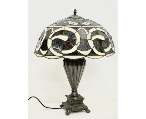 A large Tiffany style table lamp. Shade measures 52x30cm. Base 48cm. 