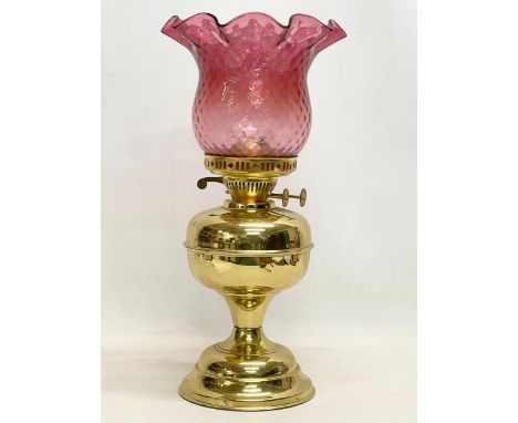 A vintage brass double burner oil lamp with Ruby Glass shade. 42.5cm 