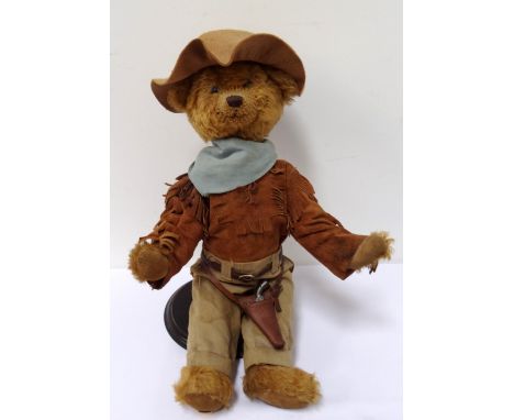 PLUSH COVERED TEDDY BEARdressed in 'Wild West' outfit, with hat, fringed suede jacket and revolver with holster, Franklin Min