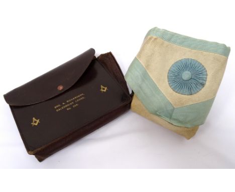 VINTAGE MASONIC APRONthe white leather body with three pale blue rosettes and edged in royal blue with two seven strand metal