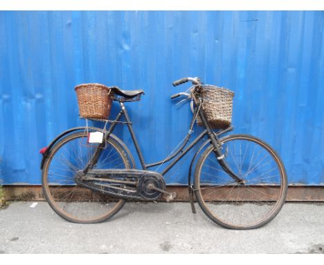 VINTAGE LADIES BICYCLEwith front and rear wicker baskets, three gears, bell, rear light, chain guard and mud guards