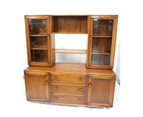 'ERCOL' ELM SIDE CABINETwith two central shelves flanked by a pair of glass door cupboards with adjustable shelves, the base 