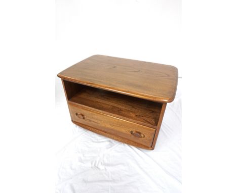 'ERCOL' ELM SIDE TABLEthe moulded rectangular top with a triangular rear drop flap above an open shelf with a drawer below, s