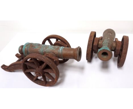 PAIR OF VINTAGE MINIATURE GARDEN/DOORSTEP CANNONSwith 24.5cm long brass barrels, raised on cast metal support frames and whee